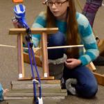 Brienna Grady adjusts her catapult, made with teammate Lexi Peterson, during the final day of testing last Wednesday at Twin Falls Middle School.                                Carol Ladwig/Staff Photo