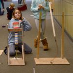 Taya Kappen and Maddi Cole anxiously watch their beanbags fly in a challenge of their two catapults for best distance. Carol Ladwig/Staff Photo