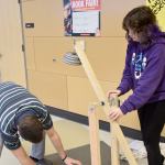 Teacher Kyle Wallace hels student Lauren Sherrill set up her catapult for a test.                                Carol Ladwig/Staff Photo