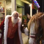 Father Christmas greets one of the hard-working draft horses who pulled wagonloads of visitors through downtown Snoqualmie for hours Saturday during the city&rsquo;s holiday festivities.