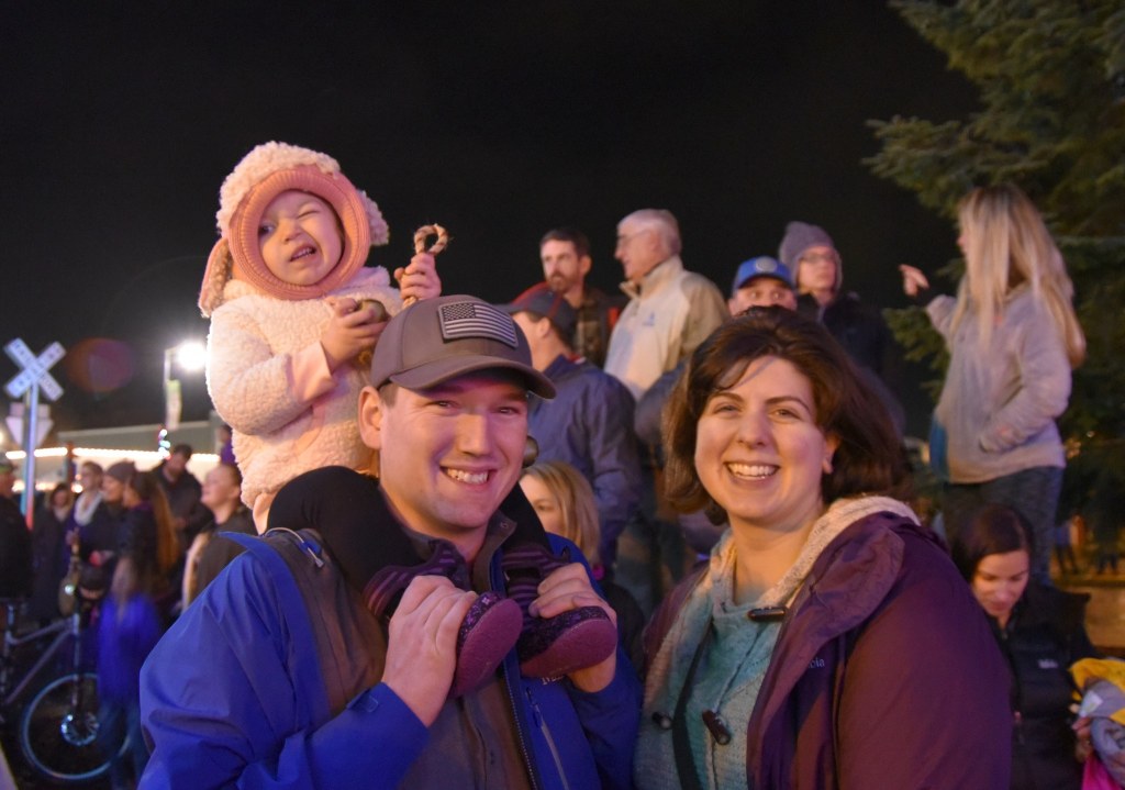 Mirko and Diana Mugglie, and daughter River, winking at the camera, enjoy their first time at a Snoqualmie tree-lighting event.