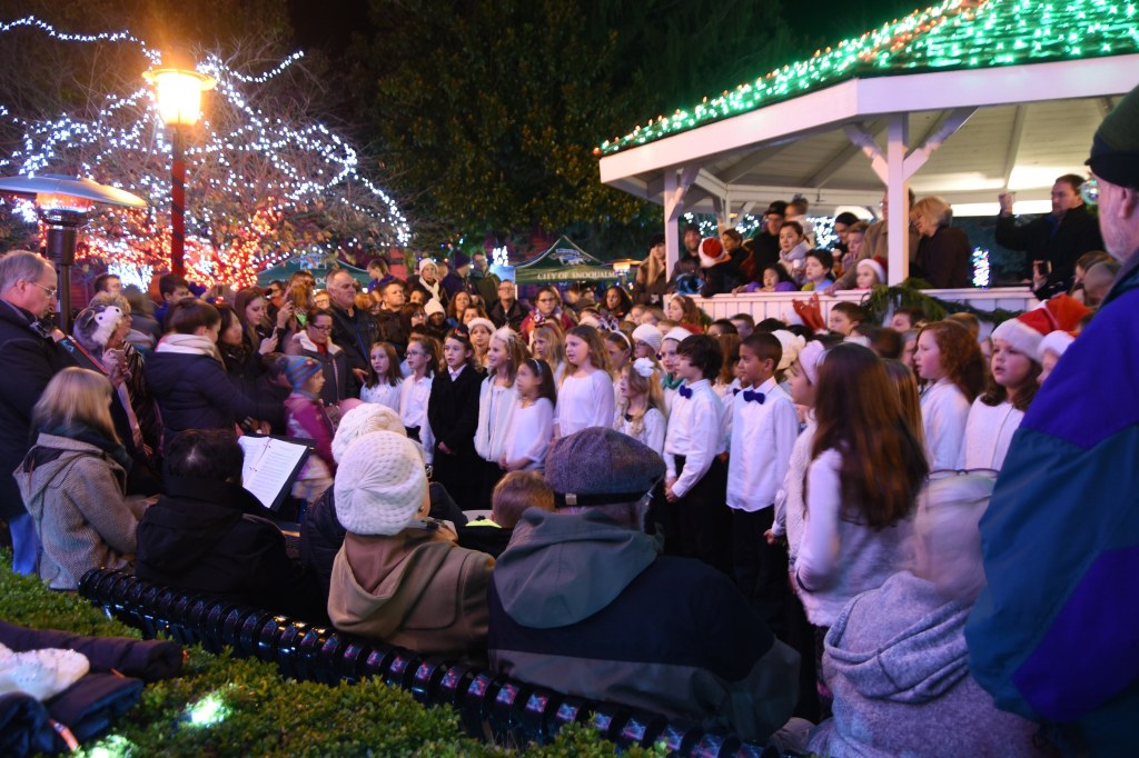 Timber Ridge Elementary School choir students, directed by Rebecca Rice, perform for a huge audience at Saturday&rsquo;s tree lighting event in downtown Snoqualmie.