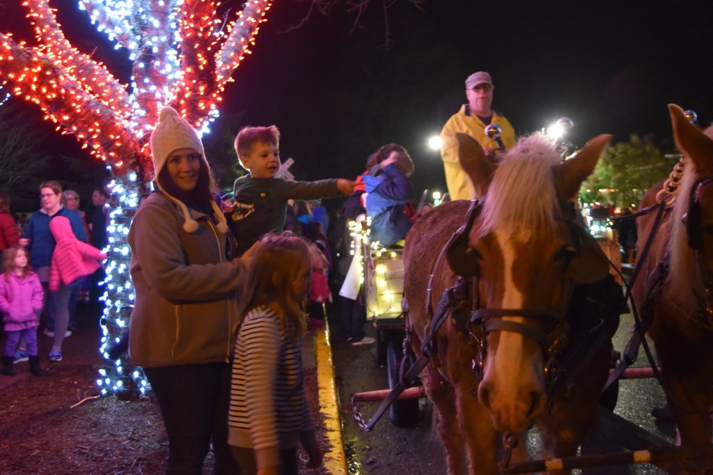 Katie Bardaro, with son Zach, 2 and Bella, 6, befriend the draft horses at work offering holiday wagon rides during Snoqualmie&rsquo;s tree-lighting festival Saturday.