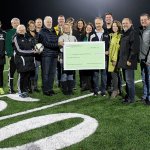 Snoqualmie Valley Youth Soccer Association board members and school board members gathered on the football field to celebrate the new CKMS sports field, and for the association to present a check to the Snoqualmie Valley School Board, Superintendent Joel Aune and Assistant Superintendent Ryan Stokes for the project.                                Courtesy Photo