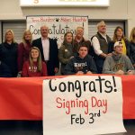 Celebrating National Signing Day, Mount Si students Camryn Buck, Tova Barden, Alden Huschle, Parker Dumas, and Colton Swain pose for a picture with their parents.                                Evan Pappas/Staff Photo