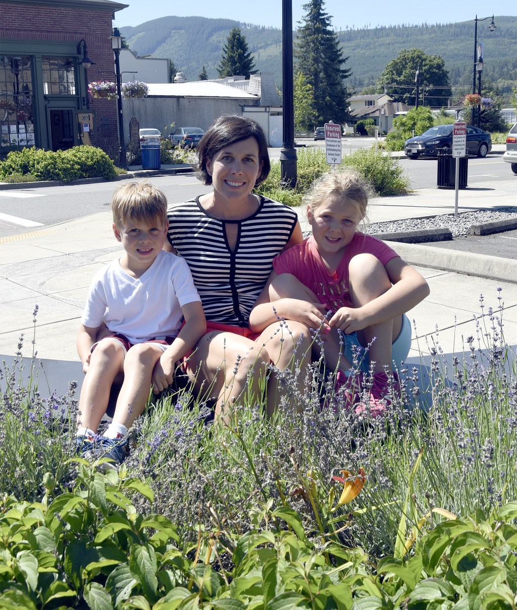 Darci Gillen Dawson, center, smiles with her two younger children, Rafe and Madeira. This summer, while on vacation in Montana, she saved a child from drowning and received the Fergus County Lifesaving Award, the first to be awarded to a civilian.                                Carol Ladwig/Staff Photo