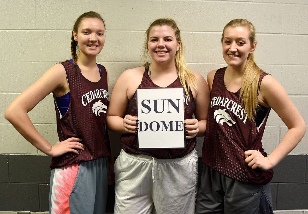 Carol Ladwig/Staff Photos                                 Team captains for the second year running for the Cedarcrest girls basketball team are, from left, Kennedy Howell, Meredith Burke holding the team&rsquo;s Sun Dome sign, and Mieke VanEss.