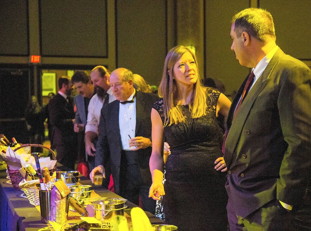 Courtesy Photo                                Guests survey the many prizes available to the highest bidder in the Chamber of Commerce Nov. 18 gala.