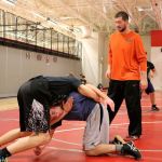 Coach Josh Mitchell instructs two students on technique during practice. (Evan Pappas/Staff Photo)
