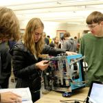 Morgan Ross calibrates one of the robots functions using her phone. (Evan Pappas/Staff Photo)