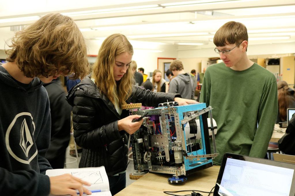 Morgan Ross calibrates one of the robots functions using her phone. (Evan Pappas/Staff Photo)