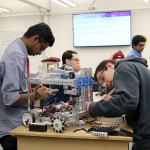 Vishnu Rathnam and Domenic Rovito put the finishing touches on their robot before the competition begins. (Evan Pappas/Staff Photo)