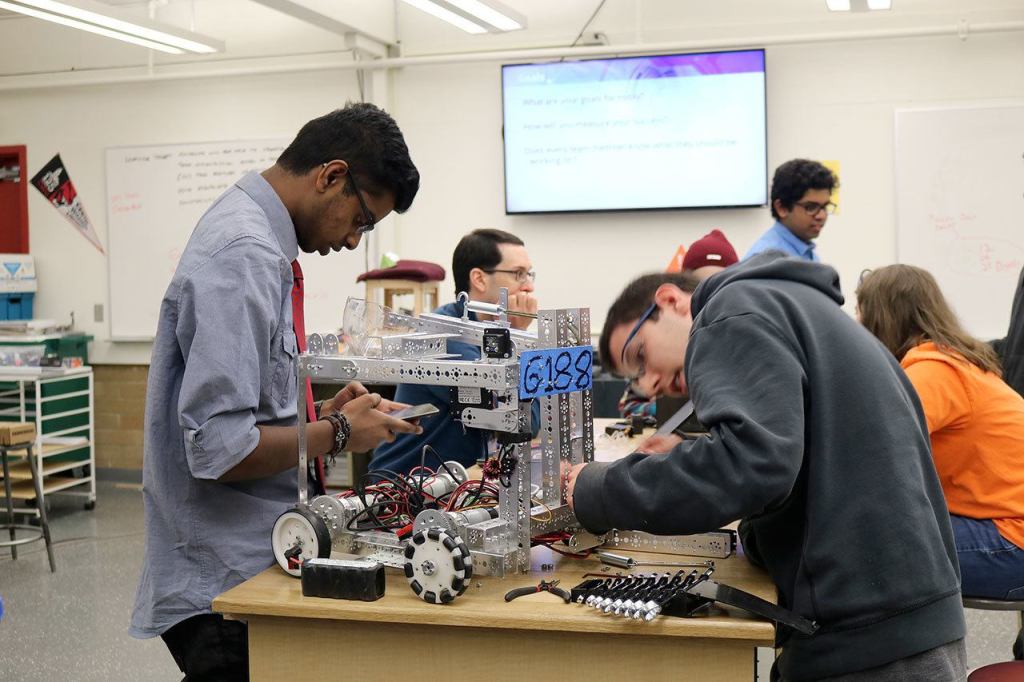 Vishnu Rathnam and Domenic Rovito put the finishing touches on their robot before the competition begins. (Evan Pappas/Staff Photo)