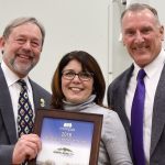 Encompass Executive Director Nela Cumming, center, presented North Bend Mayor Ken Hearing and Councilman and Mayor Pro-tem Ross Loudenback with the Community Partner of the Year award Dec. 6.                                Carol Ladwig/Staff Photo