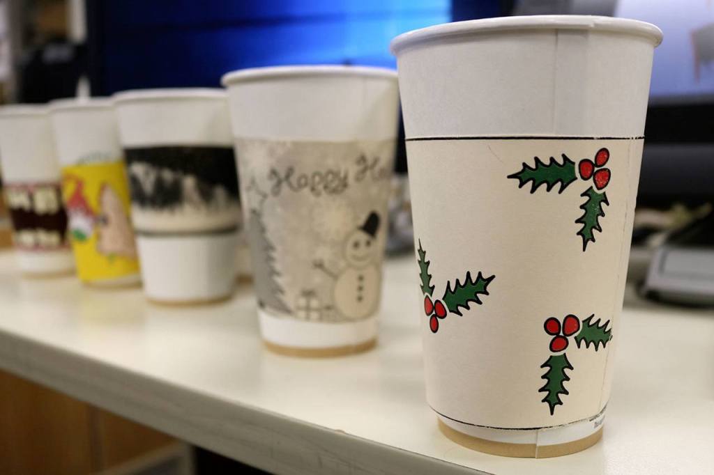 Creative student project supports food bank: Mount Si graphic designers design fundraiser coffee sleeves