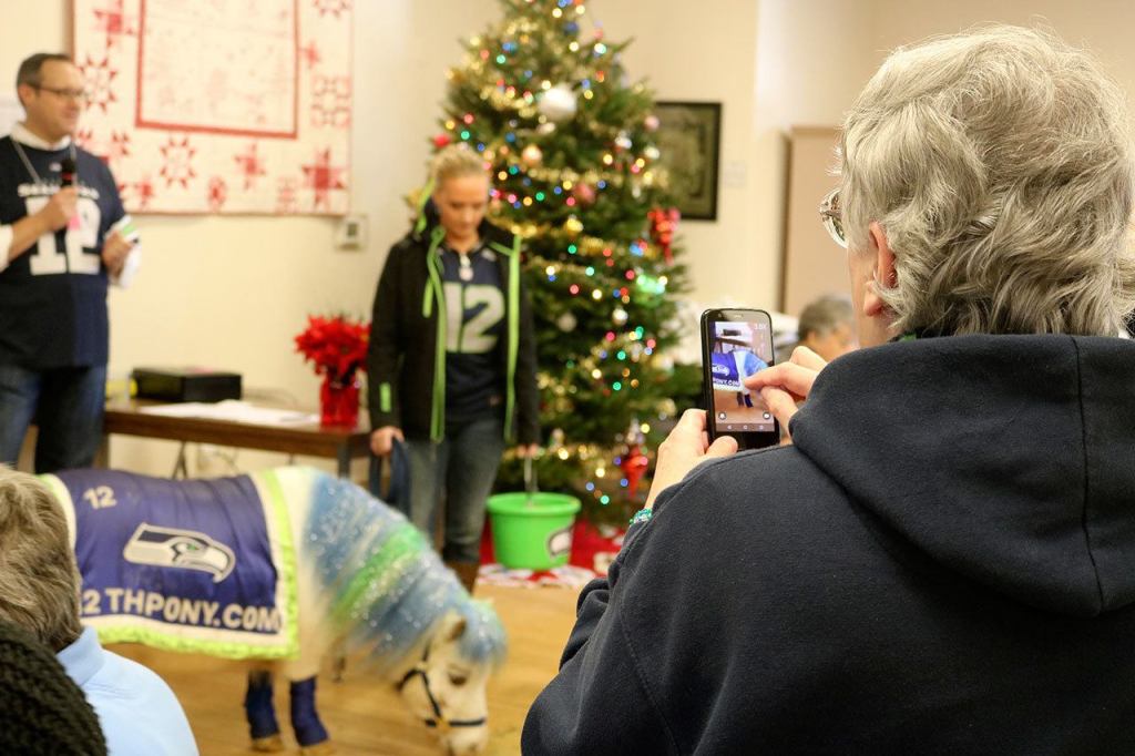 Wilson the 12th Pony draws a lot of attention from smartphone cameras as holiday lunch attendees stand up to get a good picture. (Evan Pappas/Staff Photo)