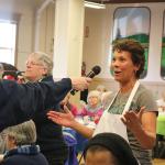Jennifer Berg, asks former Seahawk Robbie Tobeck, a question at the holiday lunch. (Evan Pappas/Staff Photo)