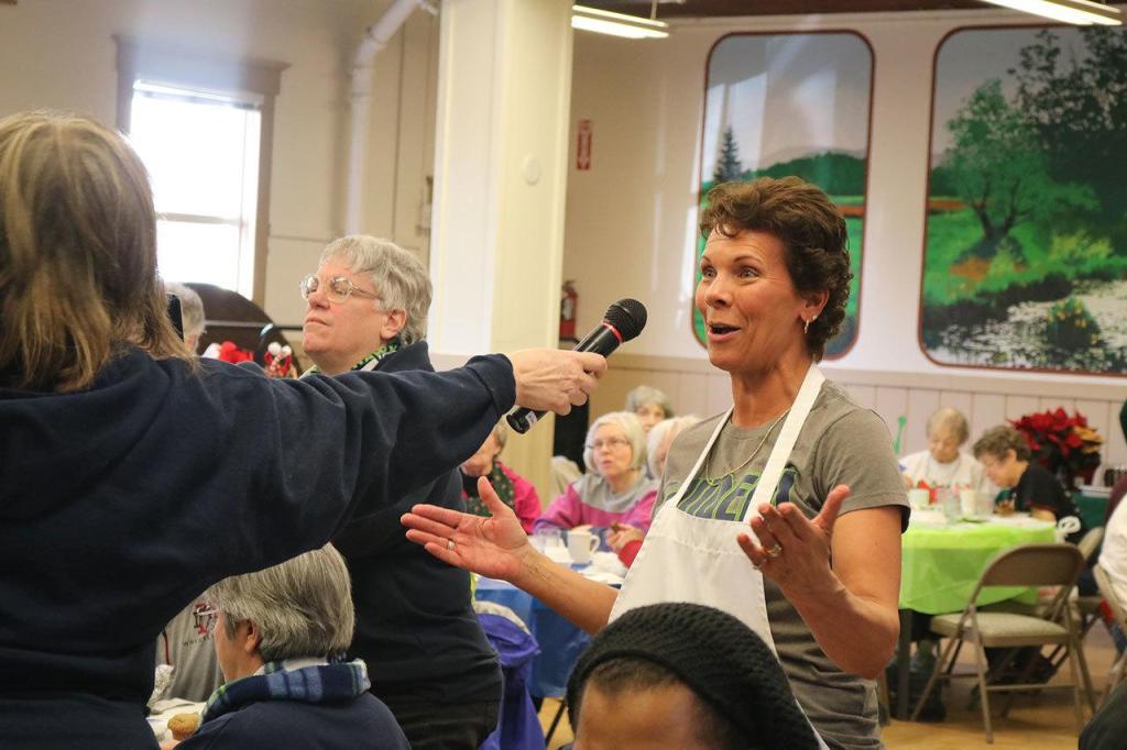 Jennifer Berg, asks former Seahawk Robbie Tobeck, a question at the holiday lunch. (Evan Pappas/Staff Photo)