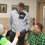 Robbie Tobeck, speaks with Renee Woodside and John Quaale after his introductory speech. (Evan Pappas/Staff Photo)