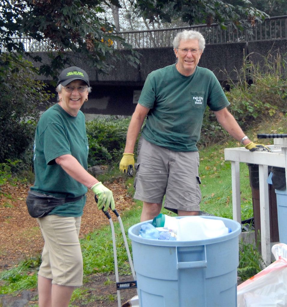 Nancy and Del Moore, recipients of the inaugural King county MLK Medal of Distinguished Service, are pictured here on a trash cleanup patrol along the river in Fall City.                                Carol Ladwig/Staff Photo