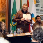 Alaa Badr, an Islamic scholar from Redmond, holds a bilingual Quran as he discusses Islam with some 200 guests at the Snoqualmie Muslim Association open house.                                Carol Ladwig/Staff Photo
