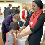 Volunteer Mariam Mohammed helped people with name tags at the 2016 open house event of the Snoqualmie Muslim Association. File Photo