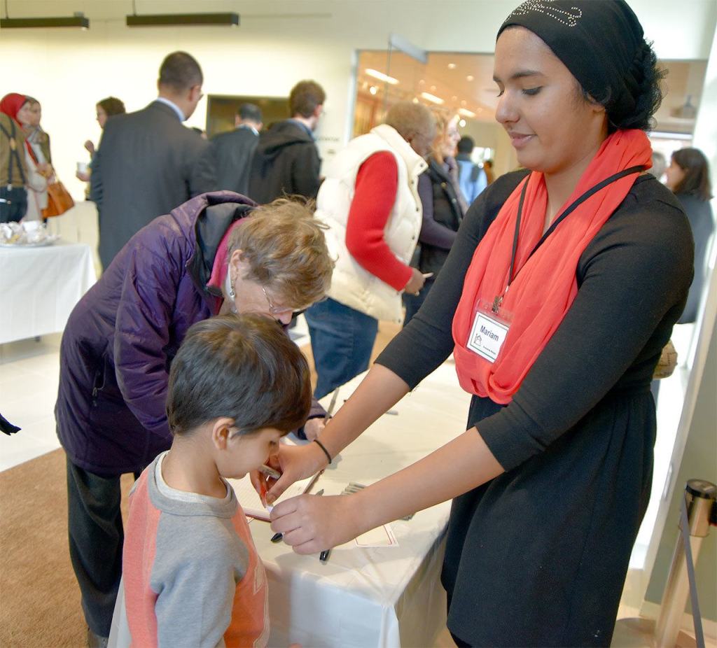 Volunteer Mariam Mohammed helped people with name tags at the 2016 open house event of the Snoqualmie Muslim Association. File Photo