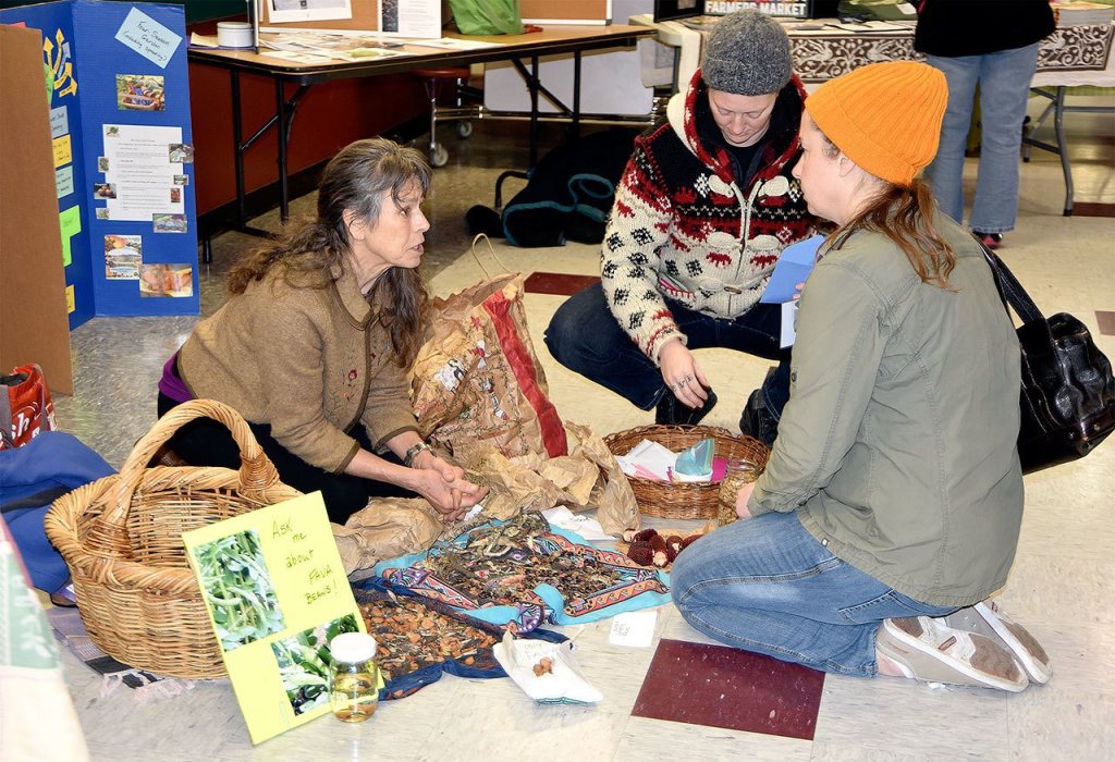 Presenter Silvermoon discusses gardening with participants in the 2016 seed exchange. File Photo
