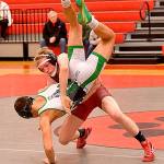 Photo courtesy of Calder Productions                                Duncan Harrison lifts his opponent Nolan Downs, of Woodinville, at the team&rsquo;s Jan. 19 meet, at home. Harrison won the match by a pin.