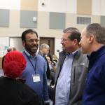 Mujeeb Mohammed speaks with Snoqualmie Valley School District Superintendent Joel Aune and School Board member Tavish MacLean. (Evan Pappas/Staff Photo)