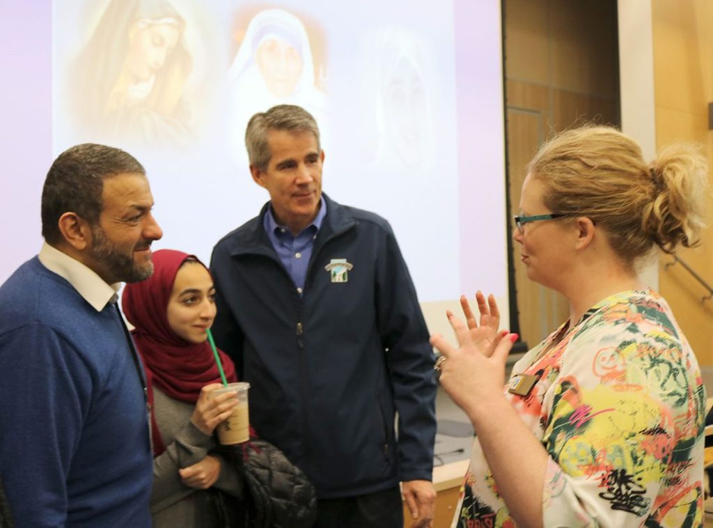Islamic Scholar Alaa Badr, his daughter Mariam and Snoqualmie Mayor Matt Larson speak with Maple Valley councilmember Megan Sheridan after the presentation Saturday. (Evan Pappas/Staff Photo)