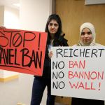 Uzam Shafique and Sadia Syed hold signs protesting the travel ban against Muslims and other actions of the Trump administration.(Evan Pappas/Staff Photo)