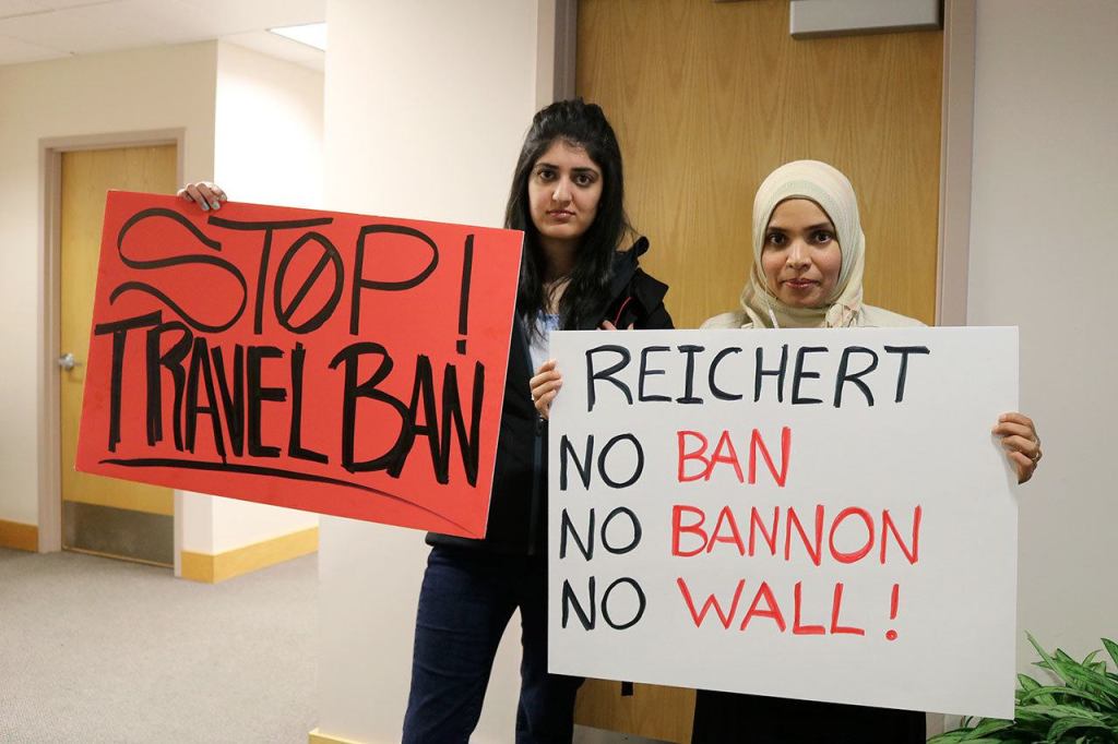 Uzam Shafique and Sadia Syed hold signs protesting the travel ban against Muslims and other actions of the Trump administration.(Evan Pappas/Staff Photo)
