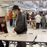 Mary Nichol and George Krasle of Woodinville take a break from the crowd to tally their seed collection.                                Carol Ladwig/Staff Photo
