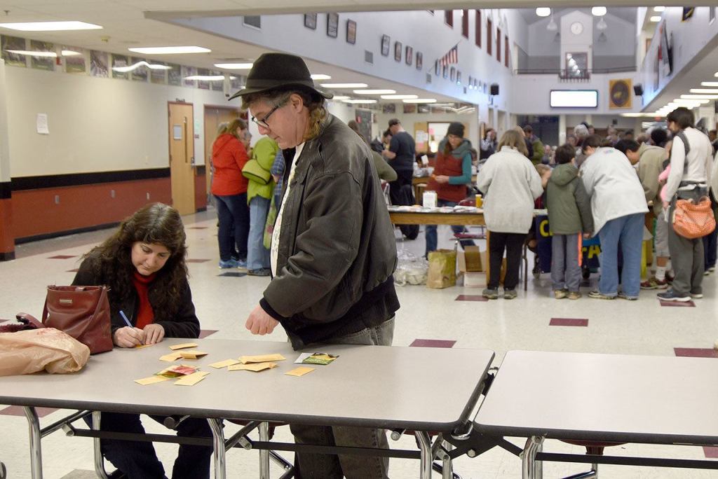 Mary Nichol and George Krasle of Woodinville take a break from the crowd to tally their seed collection.                                Carol Ladwig/Staff Photo
