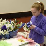 Cassidy Stallings adds to her floral arrangement at the children&rsquo;s crafts table at the Snoqualmie Valley Seed Exchange.                                Carol Ladwig/Staff Photo