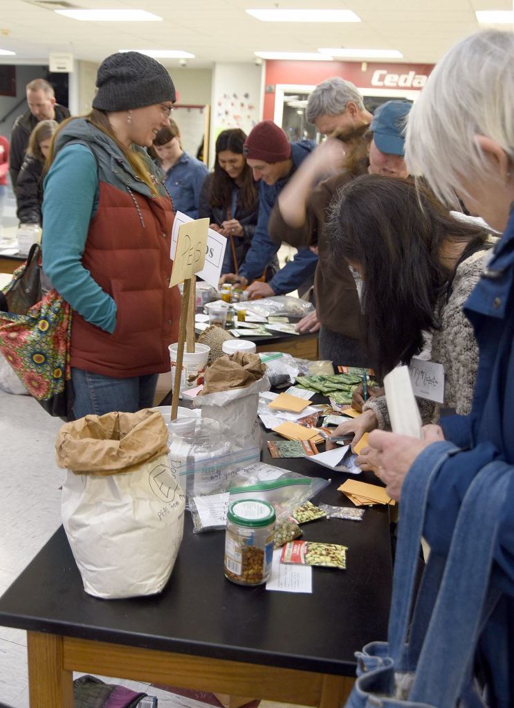 Talina Appling answers questions as seed gatherers fill their packets and jot down notes.                                Carol Ladwig/Staff Photo