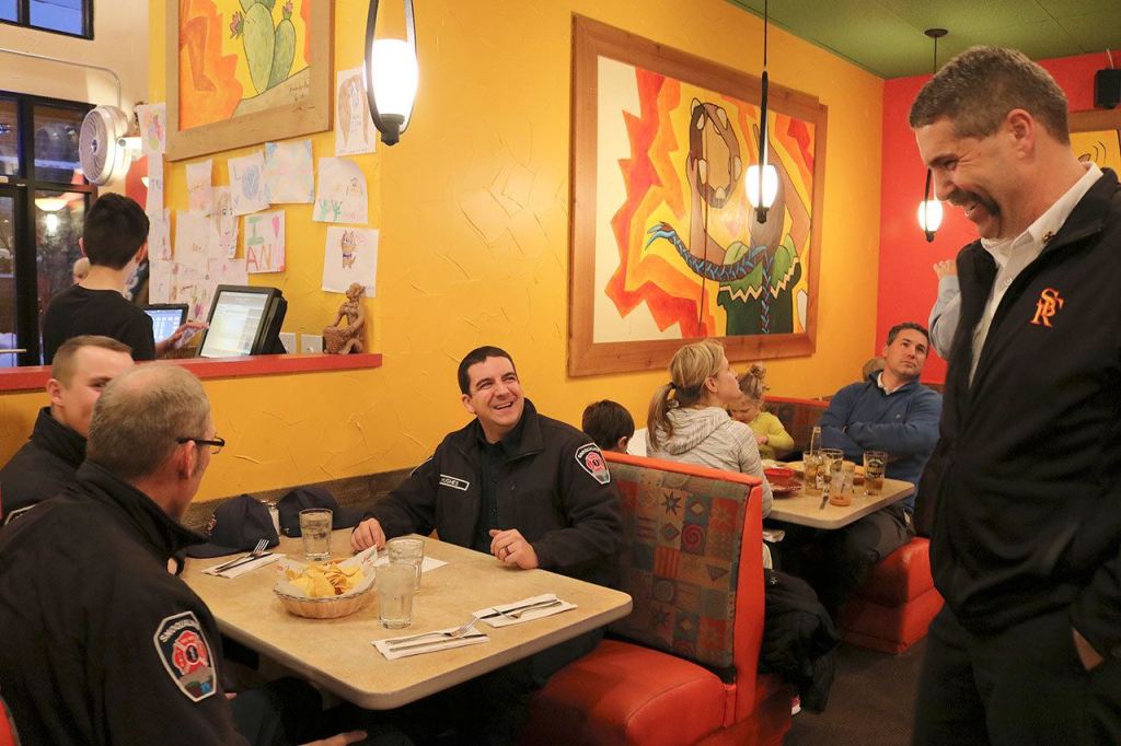 Snoqualmie Fire Chief Mark Correira serves some Enchilada&rsquo;s to other Snoqualmie firefighters who came by to support the YMCA. (Evan Pappas/Staff Photo)