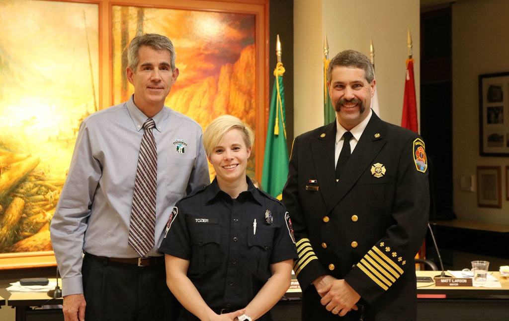 Theresa Tozier, Snoqualmie Fire Department&rsquo;s newest full-time firefighter, was presented her helmet and badge at the meeting. (Evan Pappas/Staff Photo)