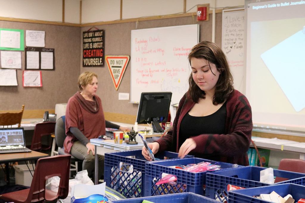 Emberly Louwien looks through some of the baskets of personal products donated for students at Two Rivers at the Feb. 10 event. (Evan Pappas/Staff Photo)