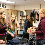 Anny Armour (left) and Jessi Bay, check out some of the clothes donated by the Mount Si Food Bank with some help from volunteer Sarah Marsh. (Evan Pappas/Staff Photo)