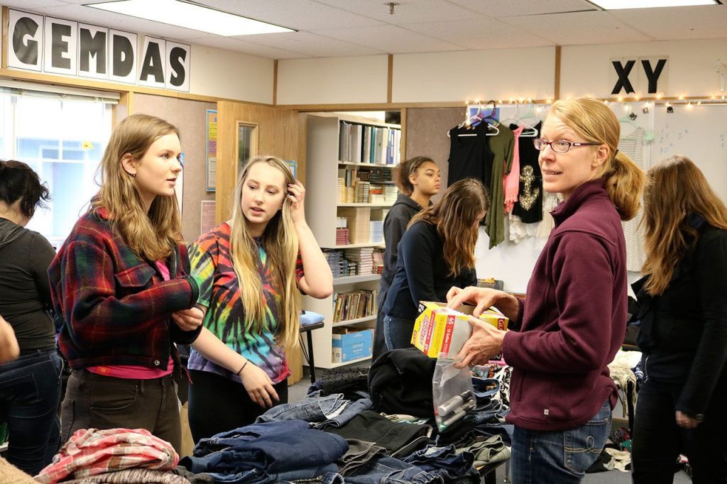 Anny Armour (left) and Jessi Bay, check out some of the clothes donated by the Mount Si Food Bank with some help from volunteer Sarah Marsh. (Evan Pappas/Staff Photo)