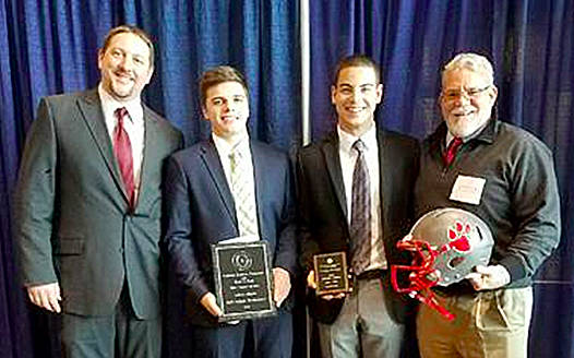 Courtesy Photo                                Mount Si High School Assistant Football Coach Steve Botulinski, far left, and head coach Charlie Kinnune, far right, congratulate student athletes Jack Weidenbach and Max Bonda at the Annual Scholar-Athlete Awards Banquet.