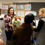 Katelyn Walker, a life skills teacher at Mount Si High School, accepts a basket of flowers from the Snoqualmie Valley Schools Foundation committee, which just announced she was the High School Educator of the Year.