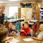 Emily Larson laughs with her students during a class activity. (Evan Pappas/Staff Photo)