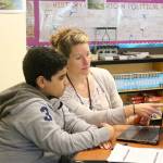 Emily Rourke helps a student with an assignment in her history class. (Evan Pappas/Staff Photo)