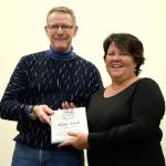 Carnation Chamber of Commerce President Eric Torrison presents Kim Lisk with a plaque March 16, in appreciation of her many volunteer efforts in support of the Carnation community.                                Carol Ladwig/Staff Photo