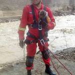 A firefighter pulls a small dog from the River as part of the city&rsquo;s restoration efforts. (Courtesy Photo)