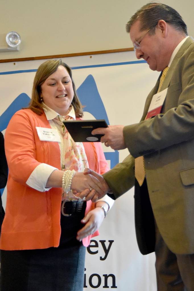 Brenna Vukovich accepts the Classified Educator of the Year award from Snoqualmie Valley School District Superintendent Joel Aune March 23 at the Snoqualmie Valley Schools Foundation luncheon. Carol Ladwig/Staff Photo