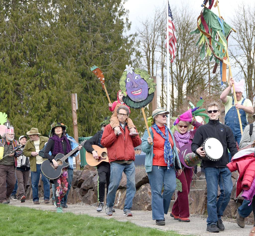 Singing and playing &ldquo;I heard it through the grapevine,&rdquo; participants in the March of the Vegetables parade arrived in a festive group for the post-parade celebration in Duvall&rsquo;s Depot Park.                                Carol Ladwig/Staff Photo